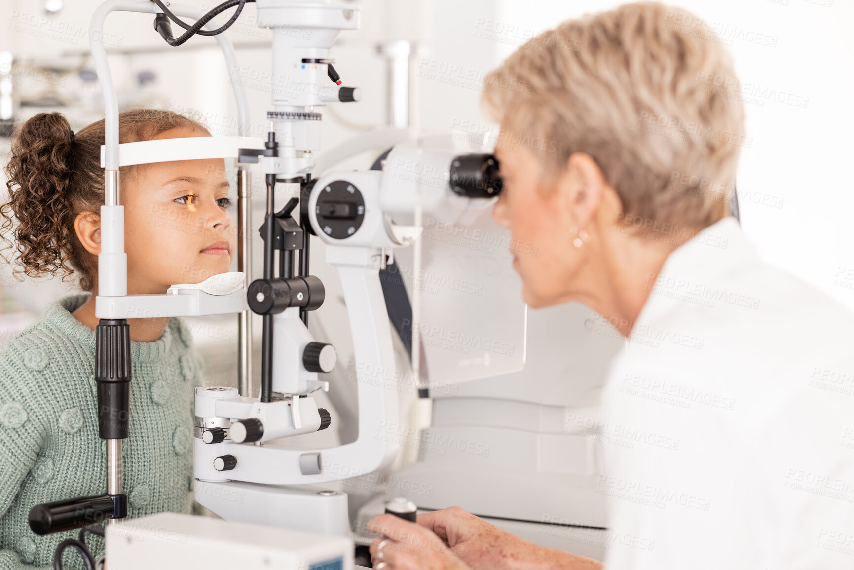 Buy stock photo Optometry, vision and optometrist doing eye test on girl for optical care, wellness and health. Senior optician doing optic examination on child with autorefractor equipment in eyewear clinic or shop