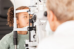 Child, kid or girl in optometry eye exam with optometrist, ophthalmologist or consulting medical profession and clinic slit lamp. Eye test, children eye care or vision check for healthcare insurance