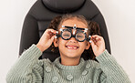 Vision, eye test and girl with trial lens for prescription spectacles at optometry shop. Eyewear, eyesight exam and happy child trying new optical lenses for optic health, wellness and care in clinic