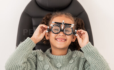 Buy stock photo Vision, eye exam and girl with trial lens for prescription spectacles at optometry shop. Eyewear, eyesight test and happy child trying new optical lenses for optic health, wellness and care in clinic