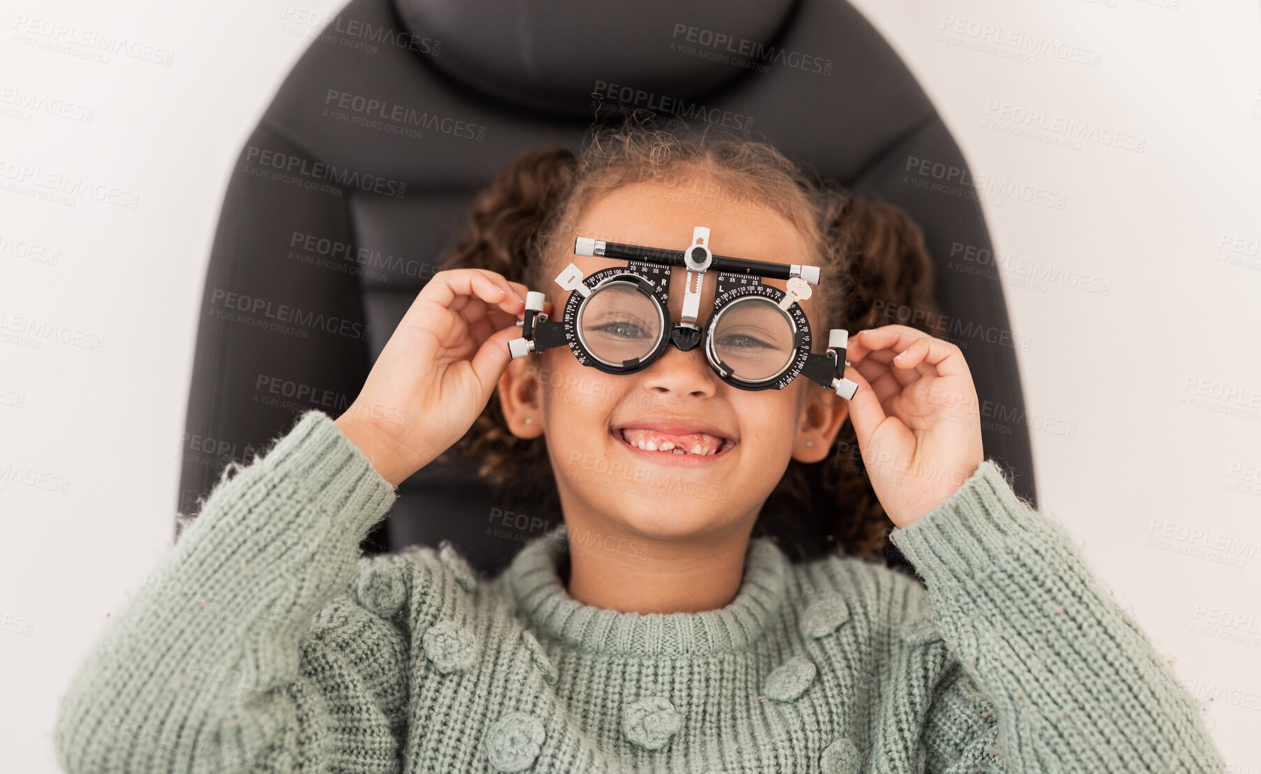 Buy stock photo Vision, eye exam and girl with trial lens for prescription spectacles at optometry shop. Eyewear, eyesight test and happy child trying new optical lenses for optic health, wellness and care in clinic