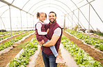 Agriculture, greenhouse farming and man with child at sustainable startup farm. Sustainability, growth and small business, dad agro farmer with happy girl in nursery with lettuce for community food.