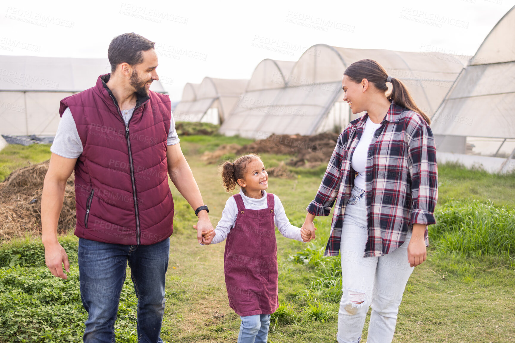 Buy stock photo Farming, field and parents holding hands with child walking on farm, bonding and happy together. Agriculture, countryside and family taking walk to check vegetables, crops and growth in greenhouse