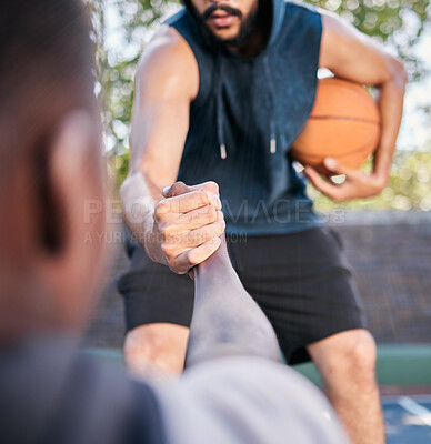 Buy stock photo Hands, basketball and help with a man athlete and rival playing a competitive game on a sports court. Team, exercise and assistance with a basketball player helping a friend during a match outside