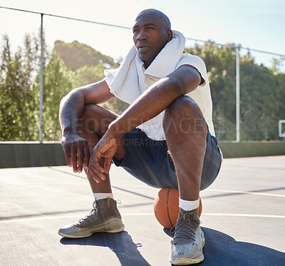 Buy stock photo Relax, fitness and man on a basketball after workout, sitting and stop for a break at basketball court, towel and sweat. Basketball player, rest and tired after training, exercise and sports practice