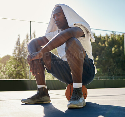 Buy stock photo Basketball, fitness and a tired black man in sports sitting on a ball at an outdoor court after a game. Workout, thinking and health with a male basketball player rest from exercise or training