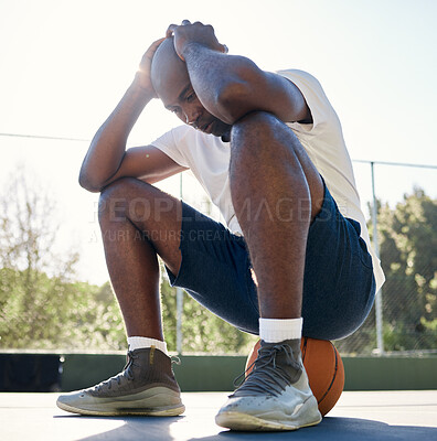 Buy stock photo Depression, sport and man on basketball court for fitness outdoors. Stressed black athlete, mental health and tired after wellness workout or exercise training burnout in sports park with ball