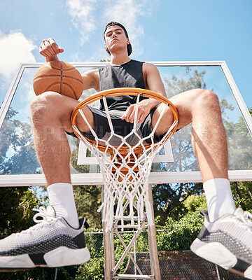 Buy stock photo Sports, basketball and man sitting on basketball hoop and preparing for training, match or competition outdoors on basketball court. Portrait, basketball player and male on rim ready for exercise.