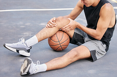Buy stock photo Basketball, man and knee in sports injury on the court holding painful, sore or tender area in the outdoors. Basketball player suffering from leg pain, joint or inflammation in sport match or game