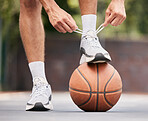 Basketball, athlete with shoelace, shoes and sport on basketball court outdoor, fitness and exercise motivation. Man, basketball player and ready for game, training and active with cardio and sports.