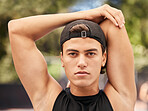 Face, fitness and stretching with a sports man getting ready for a game outdoor during summer. Portrait, health and exercise with a young male athlete going through his warmup routine for a workout