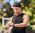 Fitness, smartwatch and sports man listening to music with earphones and gadget while outdoor for exercise, fitness and training workout. Male with watch to monitor progress, cardio and performance