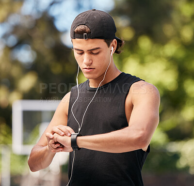 Buy stock photo Fitness, smartwatch and sports man listening to music with earphones and gadget while outdoor for exercise, fitness and training workout. Male with watch to monitor progress, cardio and performance