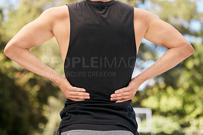 Buy stock photo Athlete with back pain, injury or accident from sports match or training on an outdoor court. Fitness, basketball and man with muscle sprain, hurt spine or medical emergency after workout or exercise