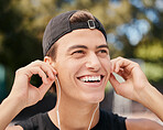 Music, fitness and exercise with a sports man listening to audio during his outdoor workout or training. Running, health and motivation with a young male athlete outside for cardio or endurance