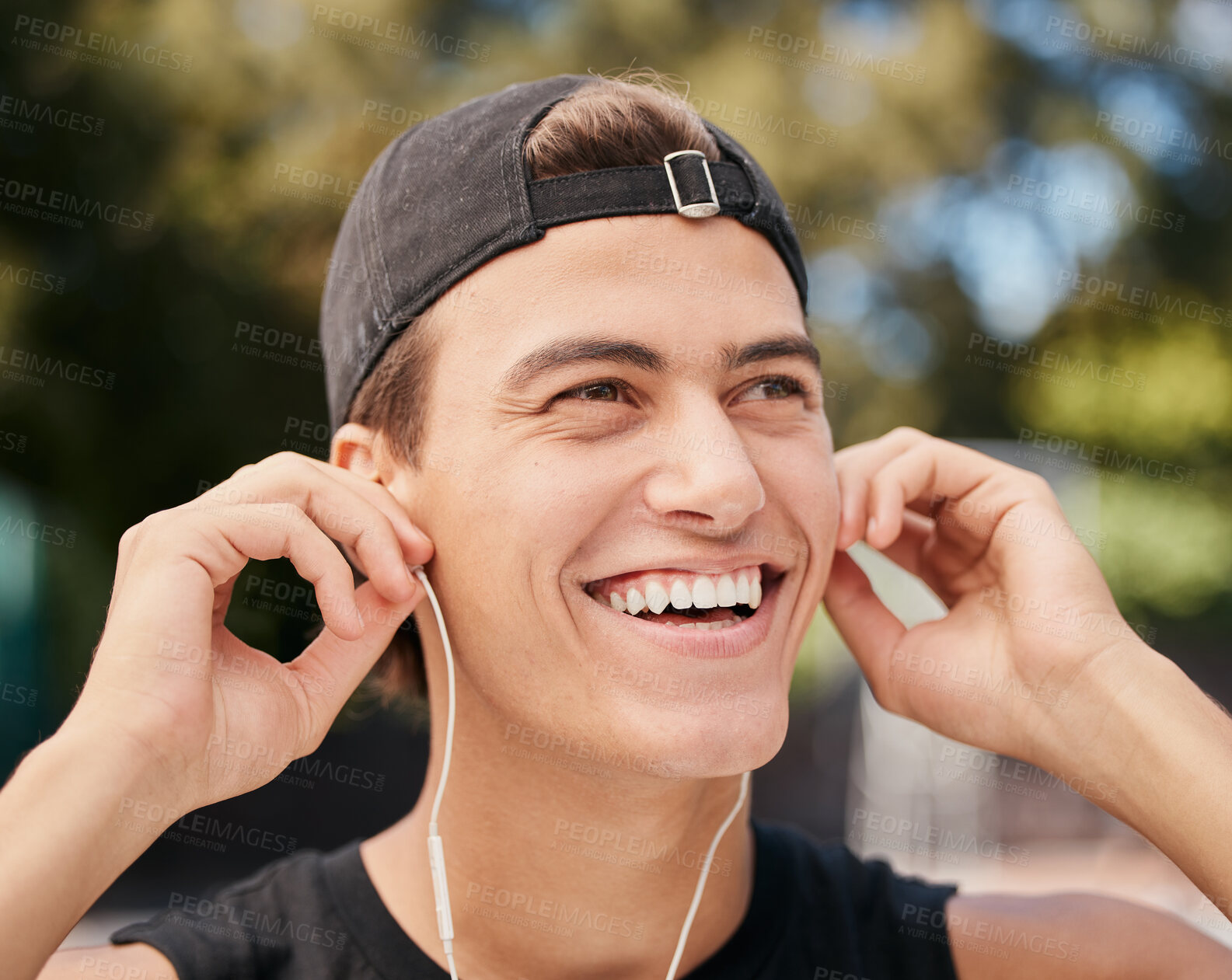 Buy stock photo Music, fitness and exercise with a sports man listening to audio during his outdoor workout or training. Running, health and motivation with a young male athlete outside for cardio or endurance