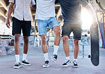 Fitness, skateboard and legs of friends at a skatepark in a city for training, sports and summer fun. Shoes, men and skateboarder group walking before a workout, practice and skating together 