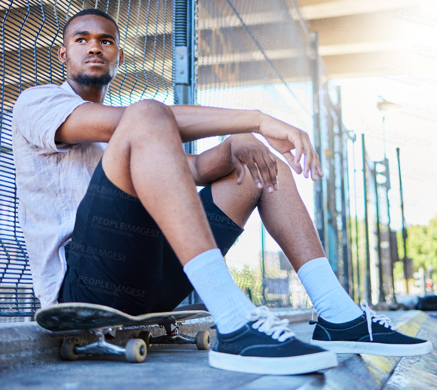 Buy stock photo Cool black man, skateboard and freedom at urban skate park, city and relaxing summer for training, outdoor action and sports hobby in USA. Young skater guy, youth culture and hipster street lifestyle