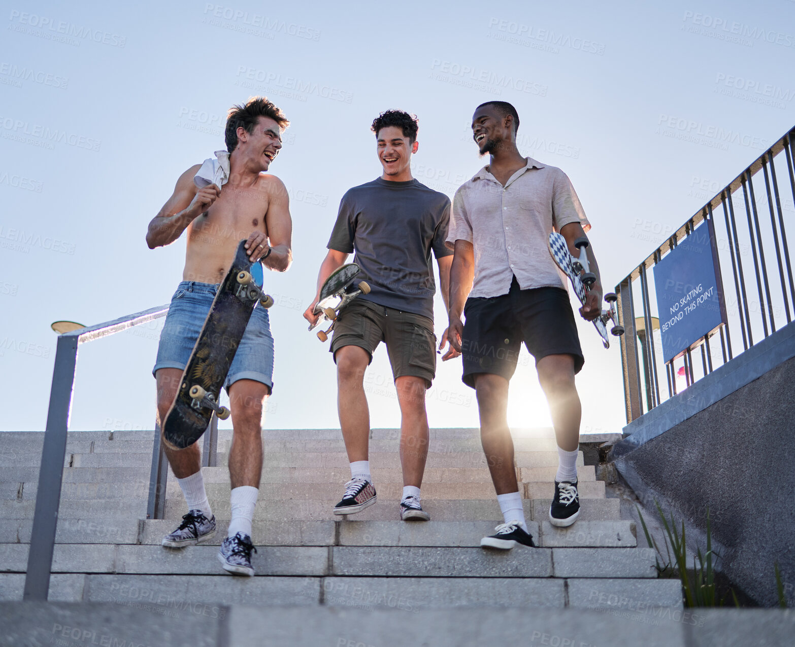 Buy stock photo friends, walking with skateboard together in city outdoors for fun, laugh and conversation support. Diversity, young gen z men talking and sport fitness lifestyle or urban trendy street fashion