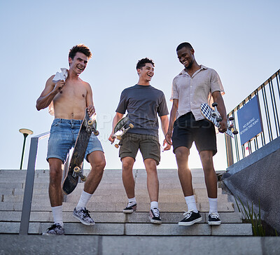Friends, city and walking with skateboard on steps, street or outdoors. Sports, skateboarding and group of skaters together after skating practice, fitness training or exercise workout in town.