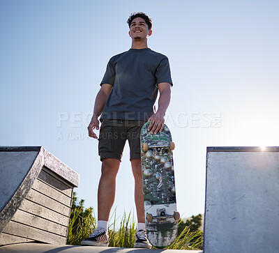 Buy stock photo Skateboard, sports and man on ramp at community skate park for freedom, exercise and fitness with smile and thinking about goal, motivation and dream. Happy skater male outdoor for fun and adventure