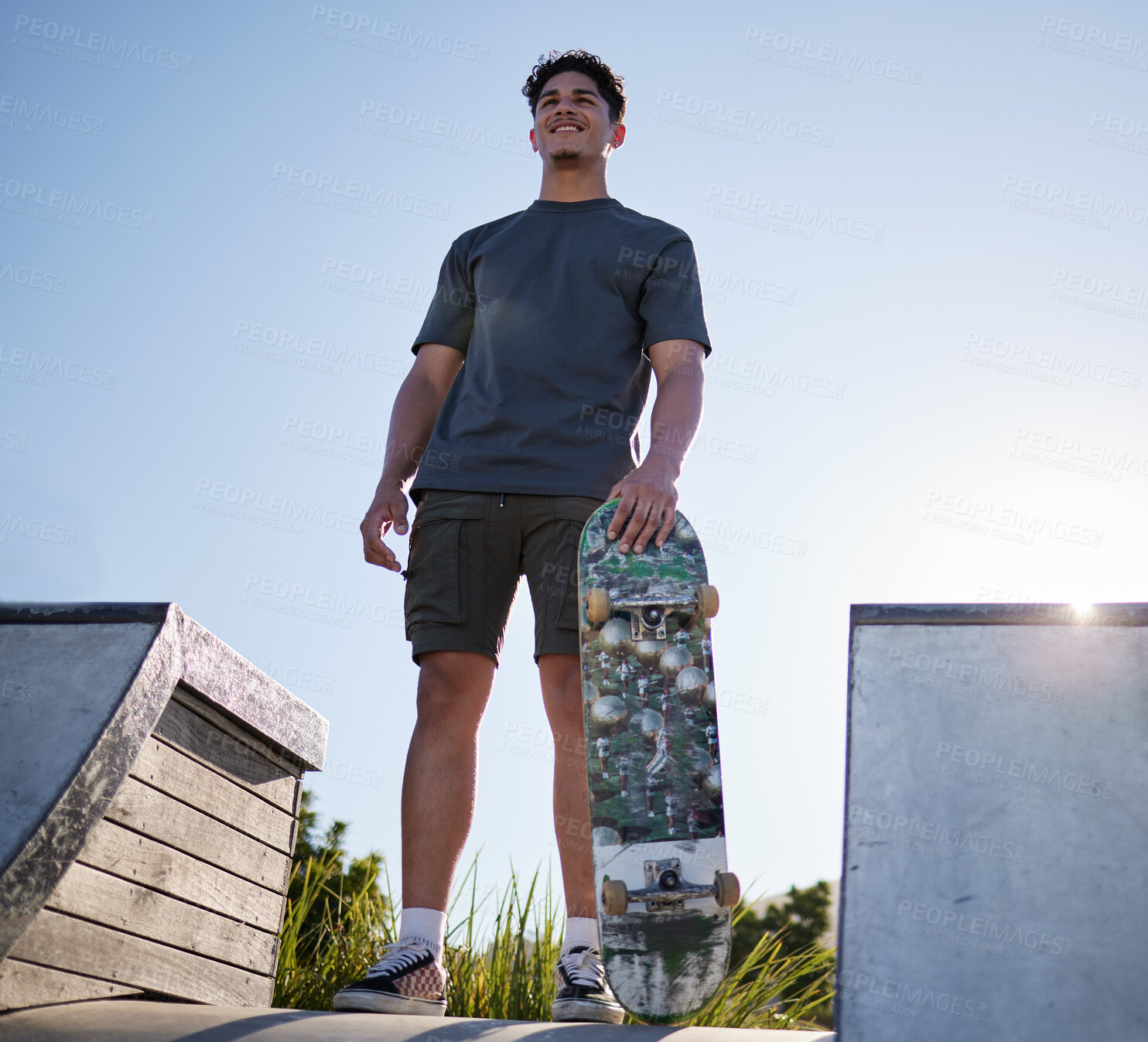 Buy stock photo Skateboard, sports and man on ramp at community skate park for freedom, exercise and fitness with smile and thinking about goal, motivation and dream. Happy skater male outdoor for fun and adventure