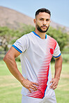 Soccer player focus on field with confidence before game, contest or competition in outdoor sport. Football man determination, pose at training, workout or sports motivation on grass pitch in summer