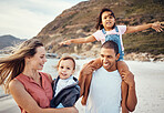 Happy family, beach and kids with parents in nature, fun and bonding while walking along the ocean. Love, happy and interracial mom, dad and children enjoy freedom, quality time and trip to the sea