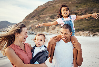 Buy stock photo Happy family, beach and kids with parents in nature, fun and bonding while walking along the ocean. Love, happy and interracial mom, dad and children enjoy freedom, quality time and trip to the sea