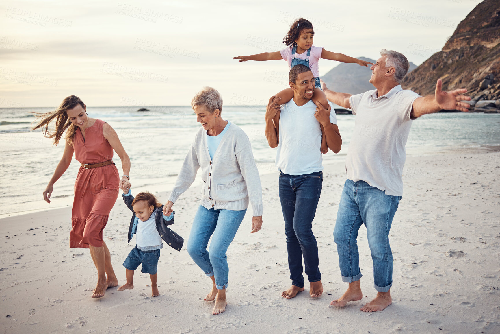 Buy stock photo Happy big family, vacation and beach walk for quality bonding time together in the outdoors. Mother, father and grandparents with children playing with smile in happiness for family trip by the ocean