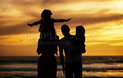 Buy stock photo Beach, sunset and silhouette of family on vacation, holiday or trip outdoors. Love, care and shadow, outline or profile of man, woman and kids enjoying quality time together or bonding by seashore.