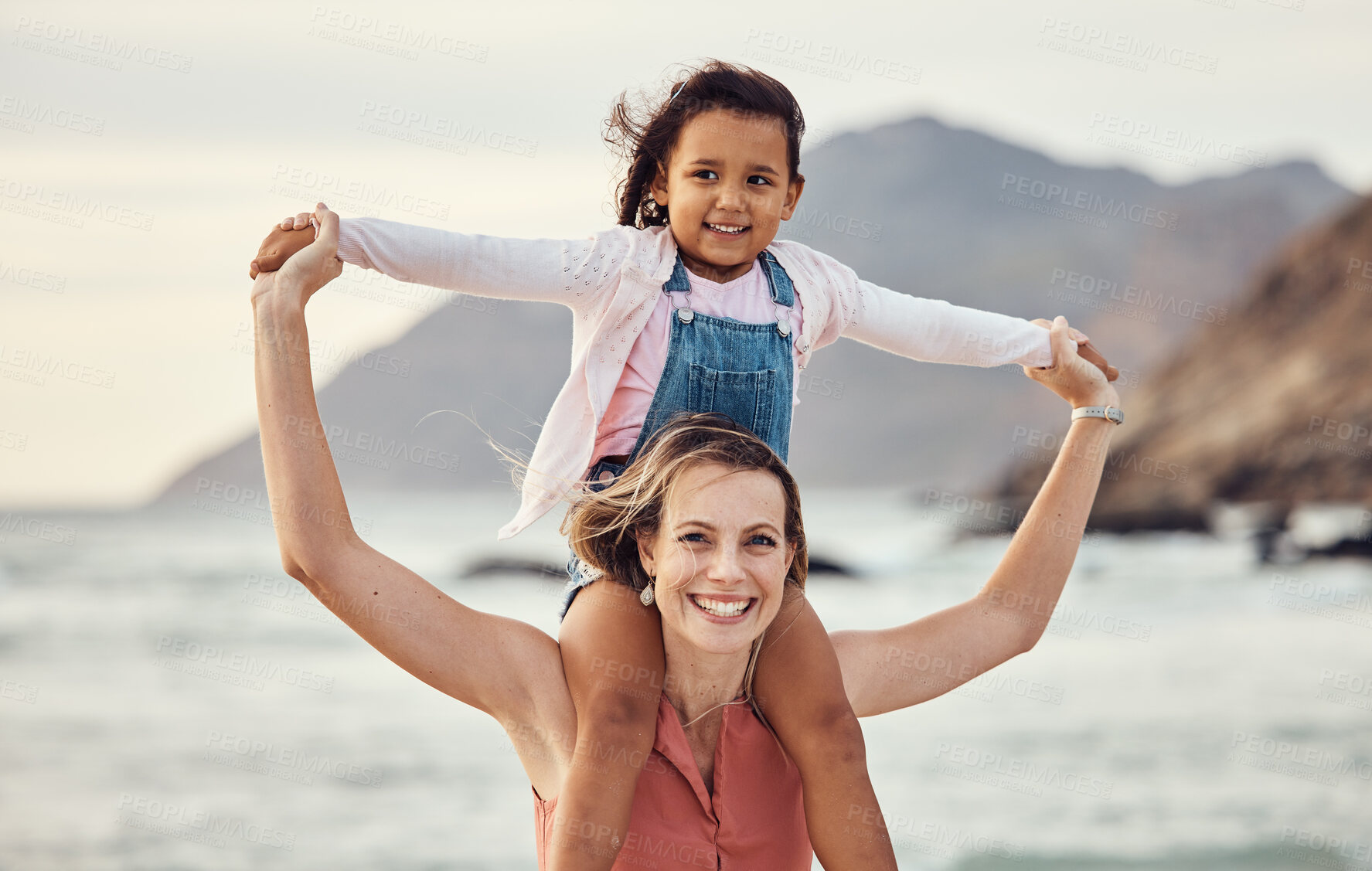 Buy stock photo Family, beach and vacation with mother and child outdoor for travel, adventure and bonding in nature for love, support and care. Portrait of woman carrying girl on shoulders by sea after adoption