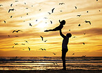 Father, flying child and beach silhouette of seaside travel holiday with birds in sunset background. Strong dad, happy kid playing and vacation trip fun together with ocean waves, sand and summer sun