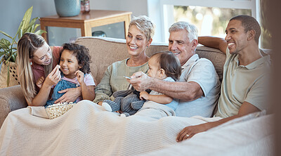 Buy stock photo Family, children and watching tv grandparents, parents and kids together on a sofa in the living room of their home. Movie, television and film with a man, woman and grandkids bonding over a video