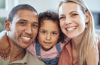 Buy stock photo Happy, smile and interracial parents with their child sitting, bonding and relaxing together. Portrait of a mother, father and girl kid with happiness, love and care on a sofa in their family home.