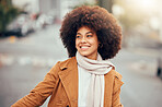 Winter, fashion and black woman in the city street for holiday, travel and happiness in Portugal. Smile, thinking and young African girl happy on a vacation in the road with fall clothes and an afro