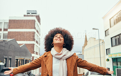Buy stock photo Black woman afro, freedom and love in the city for travel, tourism or vacation with smile in the outdoors. Happy African American female embracing free time, fresh air and adventure in the urban town