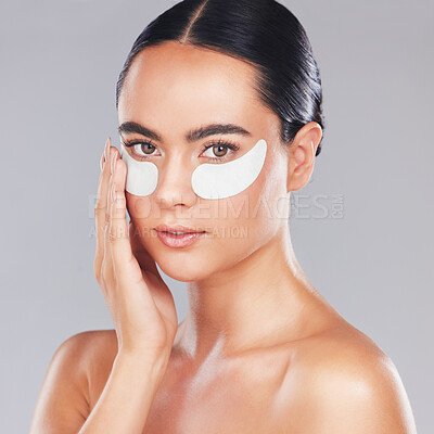 Buy stock photo Eye patches, skincare and face of woman isolated on a gray studio background. Beauty, portrait and female model from Australia with cosmetics product or collagen eye mask for health or skin hydration