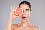Woman, natural beauty and grapefruit skincare treatment for organic treatment for natural, healthy and clean hygiene product. Surprise, wow and happy face of cosmetics model  in studio background
