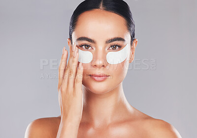 Buy stock photo Skincare, face and woman with eye patches on a gray studio background. Health, beauty or female model from Spain with facial product, cosmetics pads or collagen eye mask for hydration or anti aging

