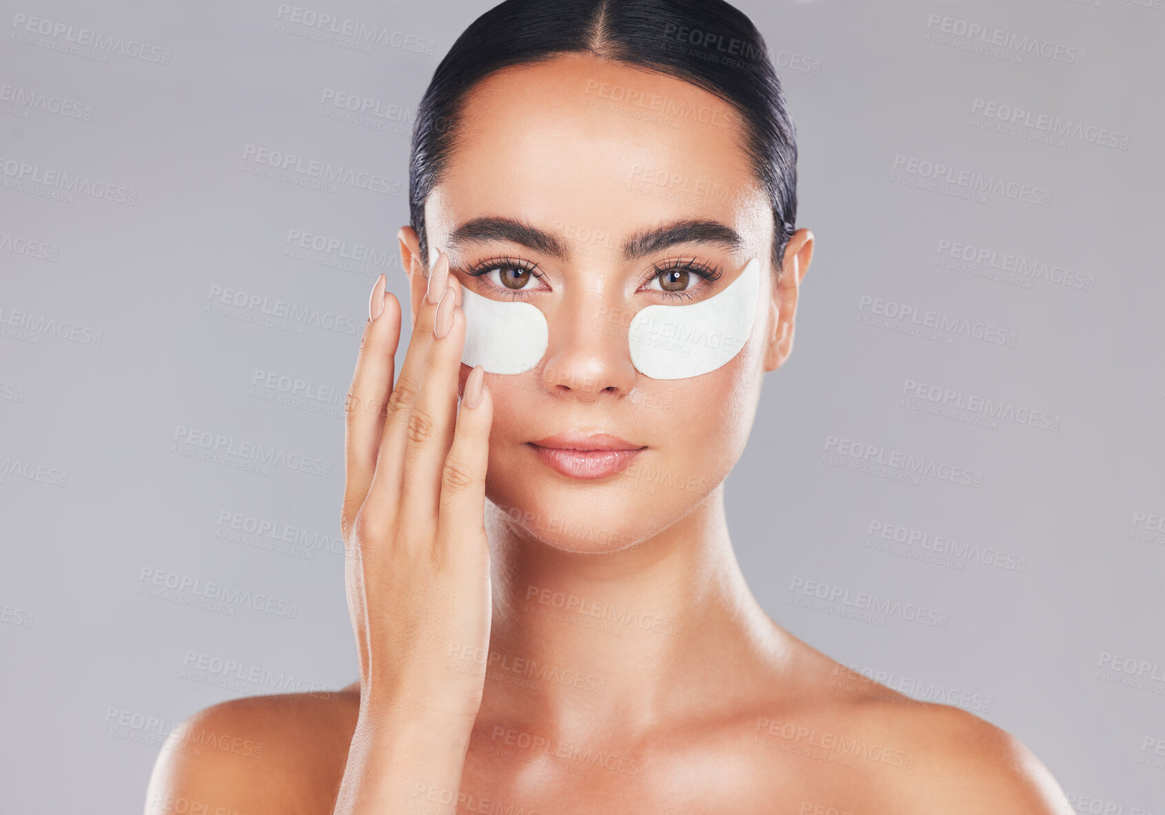 Buy stock photo Skincare, face and woman with eye patches on a gray studio background. Health, beauty or female model from Spain with facial product, cosmetics pads or collagen eye mask for hydration or anti aging

