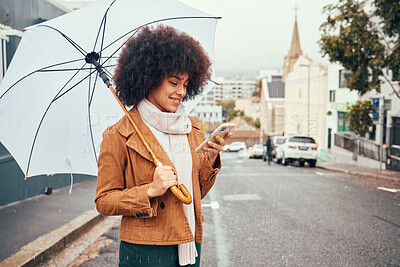 Buy stock photo Black woman, winter on city street and smartphone in hand browsing social media, online conversation and umbrella in hand waiting for taxi in rain. Mobile GPS technology, happy smile and cell message