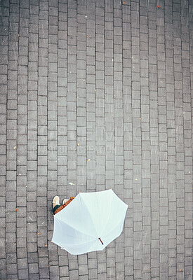 Buy stock photo Top view, rain and person with umbrella in city, street or urban road mock up. Travel, freedom and pedestrian with parasol on asphalt in winter weather traveling, standing or enjoying time outdoors