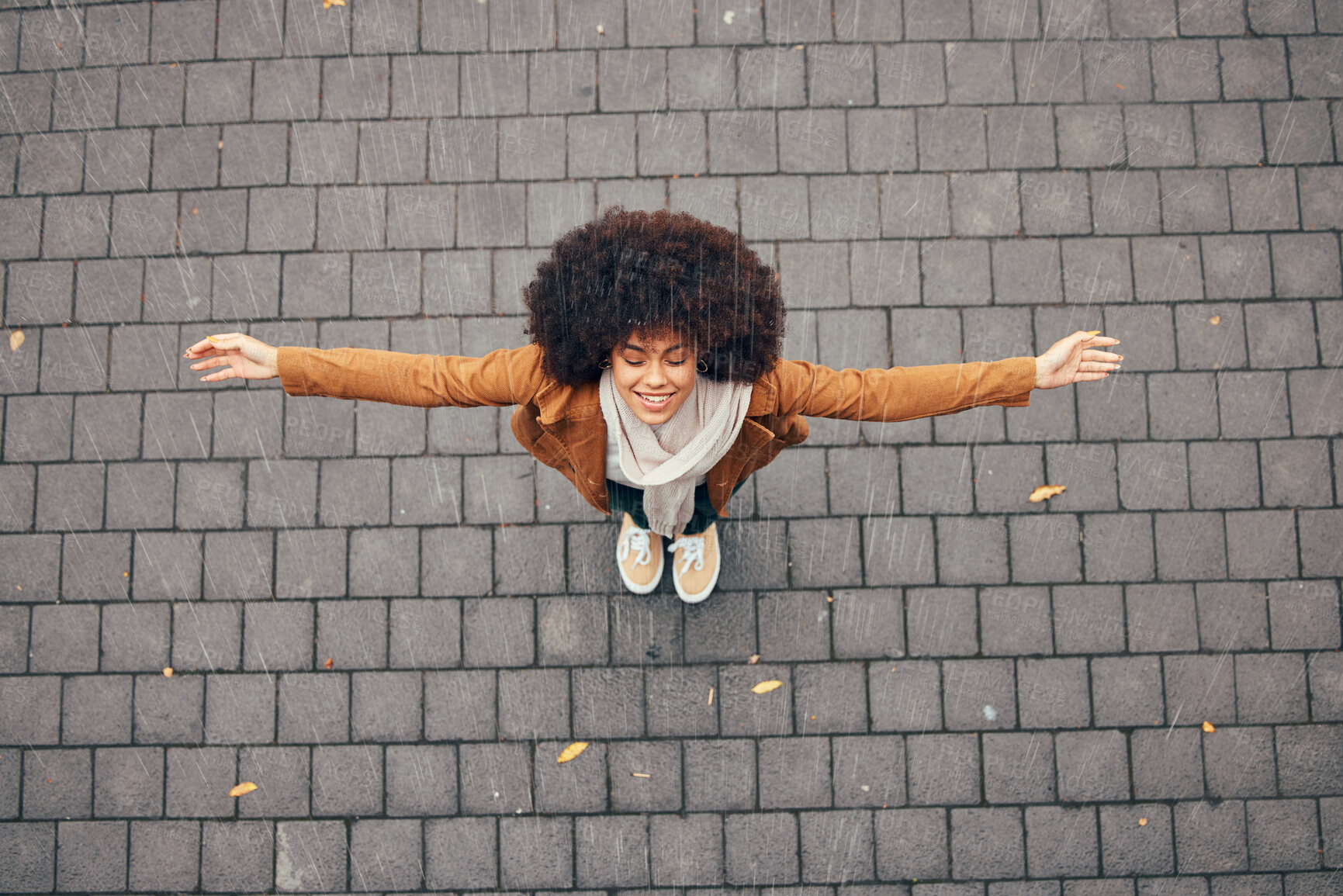 Buy stock photo Young black woman, rain and freedom in urban city street, winter weather and celebration for excited lifestyle, joy and happiness on wet road. Happy woman celebrate raining day on outdoor sidewalk 