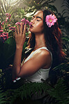 Young woman, nature and smell flowers, plants and content with environment, happy and peaceful outdoor. Female, girl and happiness, with natural aroma, fragrance or joy for scent, cheerful and floral