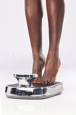 Buy stock photo Black woman, feet and scale to measure weight, diet and weightloss against a white studio back with mockup. Foot, health and wellness with female check body mass, bmi and gain or standing on machine