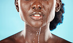 Water, mouth and face of a black woman with drops on her lips for hygiene, grooming and cleansing. Beauty, skincare and hydrating facial for an african american female with oral cleaning treatment