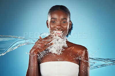 Buy stock photo Black woman, water and splash with beauty portrait of happy skincare, shower and wellness. Hydration, fresh and clean hygiene with face model for luxury, relax and spa in a blue background in studio