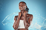 Beauty, skincare and splash, portrait of black woman with blue background in studio shoot. Fashion, health and fresh clean water splash for woman with healthy mindset, lifestyle body care in Africa.