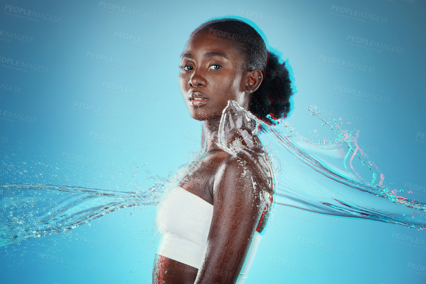 Buy stock photo Skincare, water and black woman with a splash for hydration, cleaning and beauty against a blue studio background. Spa, wellness and African model with peace, calm and relax from liquid bodycare